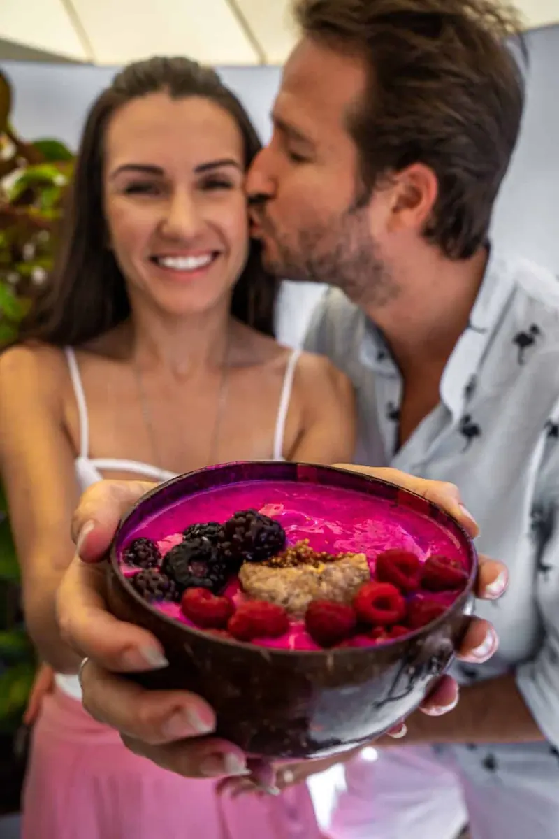 Olivia and her husband with a smoothie bowl